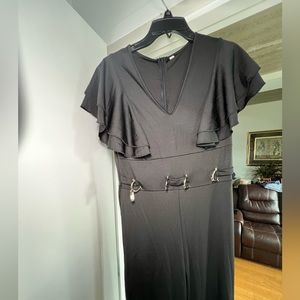 Black Frill short sleeve jump suit. Long pants.buckles in the front. Zipper back